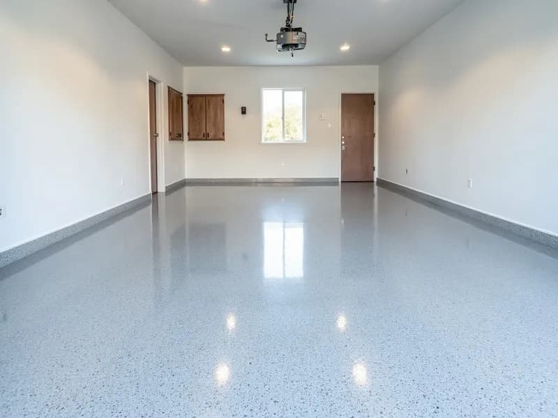 Glossy gray flake epoxy coating on a residential garage floor